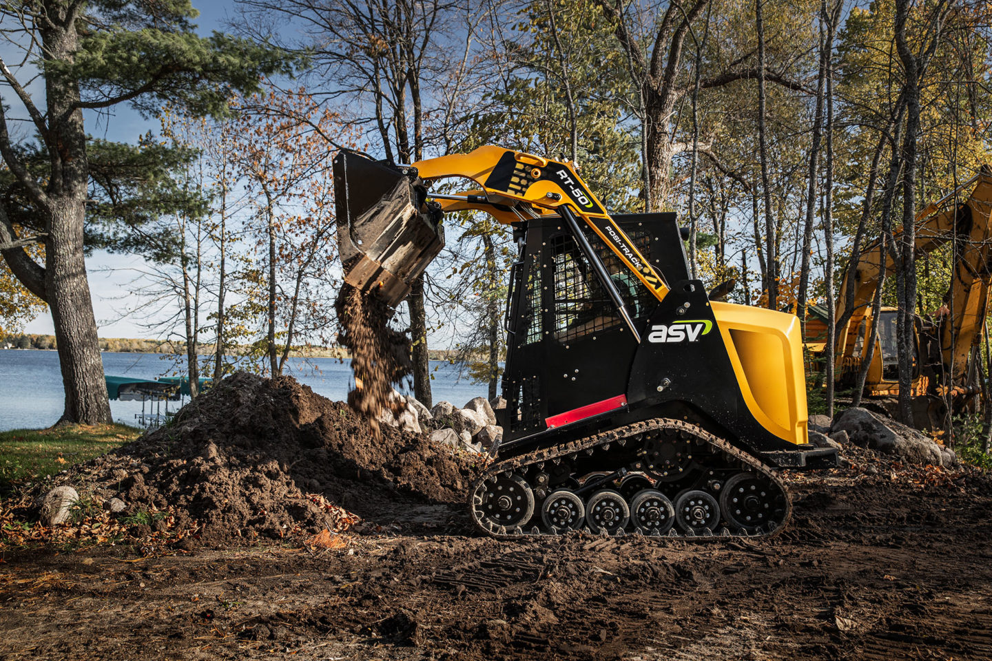Skid loader moving material on a lakefront job
